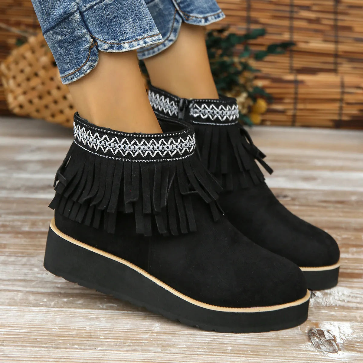 Women's thick bottom wedge bootie in suede with side zipper and tassel detail, available in multiple colours.