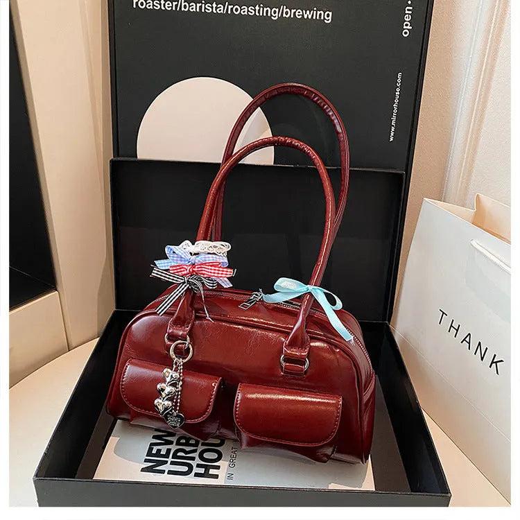 Retro brown PU leather women's pillow bag with a double shoulder strap and flap closure.