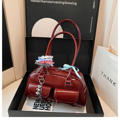 Retro brown PU leather women's pillow bag with a double shoulder strap and flap closure.