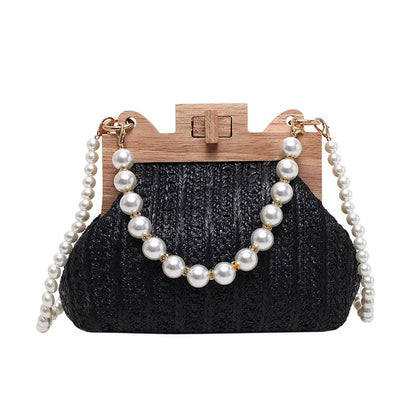 Women's beige straw woven shoulder bag with pearl chain strap, showing horizontal square shape and sewing line detail.