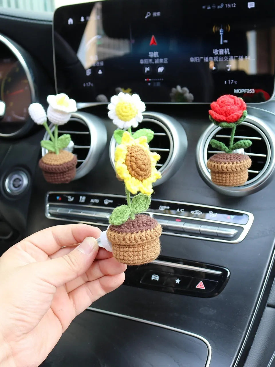 Creative wool potted plant car air vent clip aromatherapy pendant on a car vent.