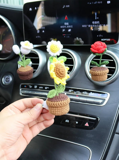 Creative wool potted plant car air vent clip aromatherapy pendant on a car vent.