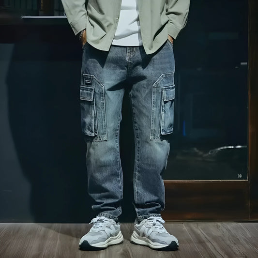 Men's blue loose straight leg jeans with a zip fly, shown on a model.