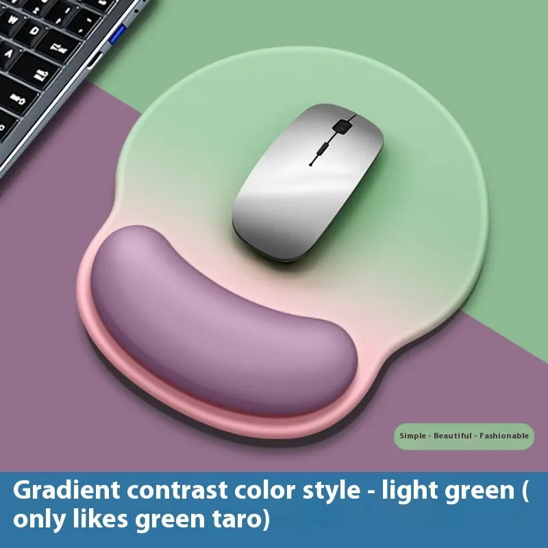 Silicone mouse mat with wristband in a gradient blue black colour pattern on a desk.