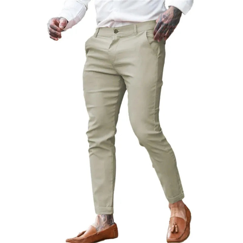 Men's slim fit elastic cotton pencil trousers in a solid colour on a hanger, showing the zip fly and mid waist design.