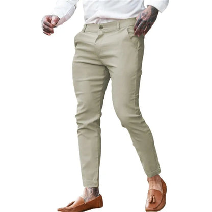 Men's slim fit elastic cotton pencil trousers in a solid colour on a hanger, showing the zip fly and mid waist design.