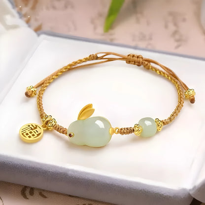 Hetian jade geometric rabbit charm on a yellow string bracelet for women.