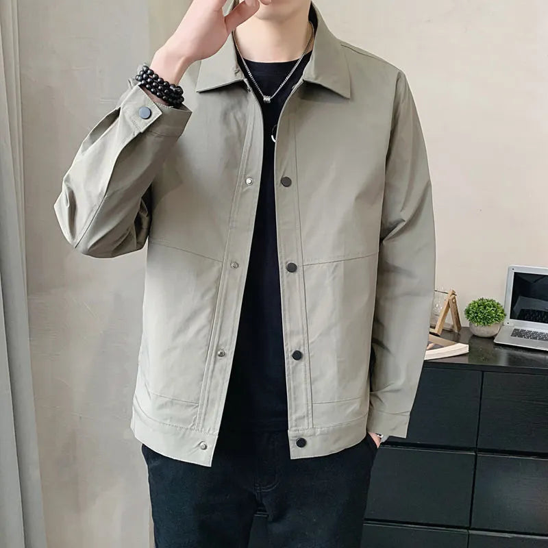 Man wearing a slim-fit light grey single-layer Korean-style jacket with long sleeves.