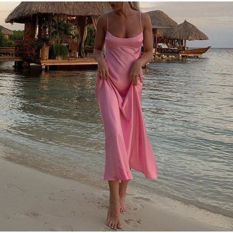 Elegant satin slip dress in pink with a flattering, form-fitting silhouette and sexy backless design