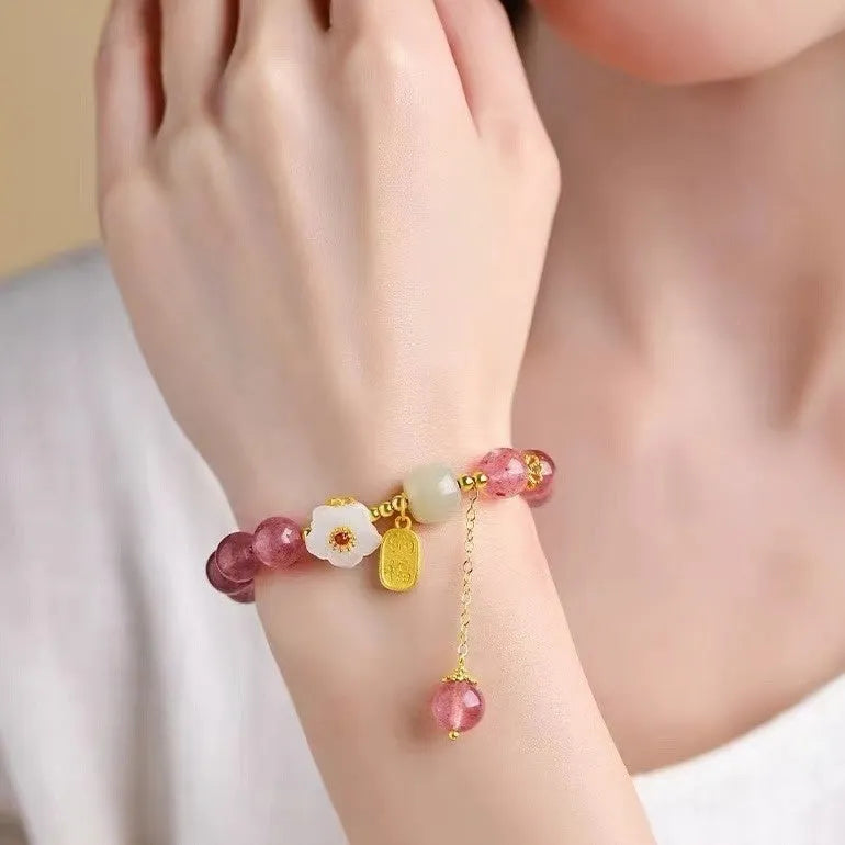Handcrafted strawberry quartz crystal bracelet with adjustable string closure and Hetian jade peach blossom design