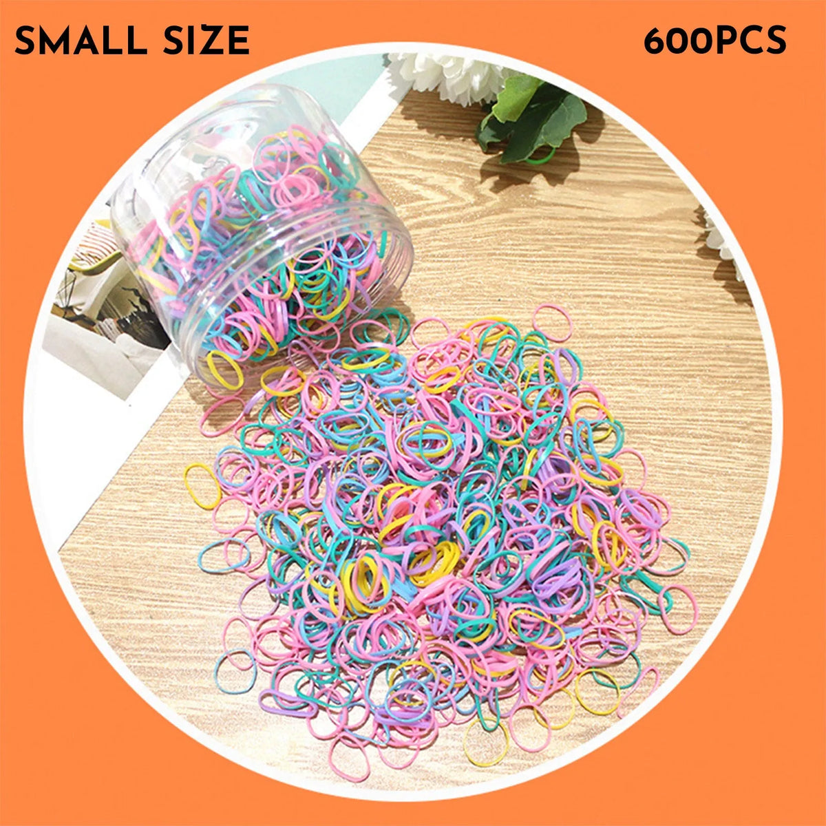 Multicoloured assortment of thin TPU elastic hair bands for babies and children in a reusable plastic container.