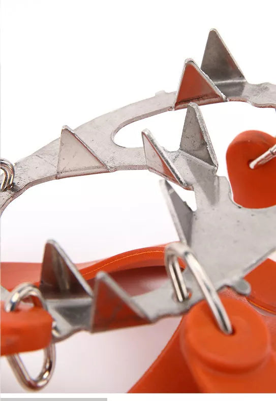 Reinforced large-tooth non-slip shoes in black and orange for superior traction on slippery surfaces