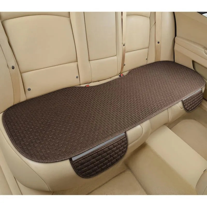 Linen car cushion with plaid pattern in cream colour on automotive seat