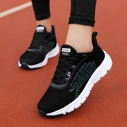 Women's black running sneakers with MD soles and cross strap detailing for jogging
