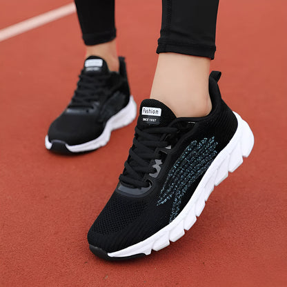 Women's black and white low-top running casual sneakers with MD sole and cross strap detail
