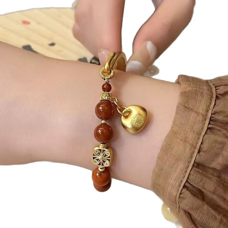 Golden antique-style Southern Red Agate Character Ingot half bracelet for women with lucky bag design.