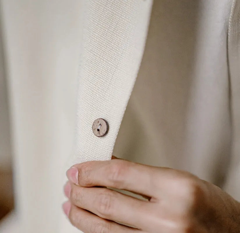 Light apricot men's shirt with a bamboo plant pattern and a Cuban collar laid flat.