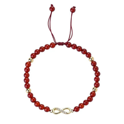 Hand-woven red agate beads bracelet with lucky charm in ethnic style, showing diamond-shaped beads.