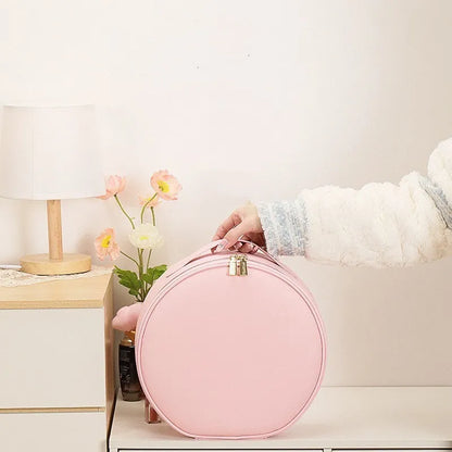 Round black LED light makeup bag with built-in mirror, carry strap, and open compartment showing internal partitions.