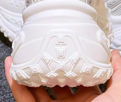 Women's white height increasing shoes with lace-up design and round toe, showing internal insole construction