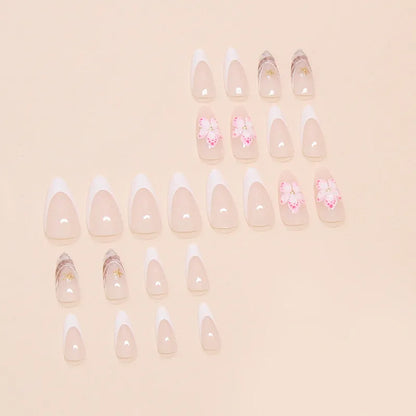 Set of floral French tip false nails with grey rock pattern accents on a simple pink base.