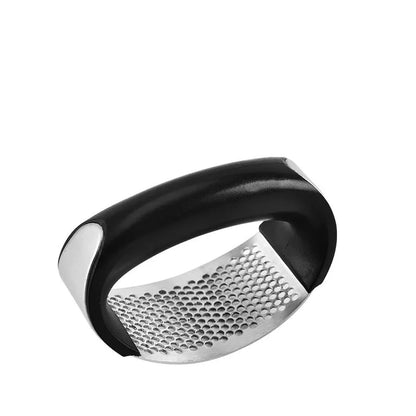 Stainless steel garlic press with ergonomic handle in kitchen setting