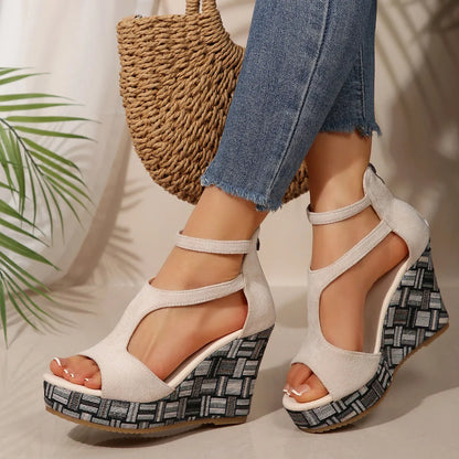 Women's thick-soled ankle-strap buckle sandals in cream white, showing cloth upper and rubber sole.