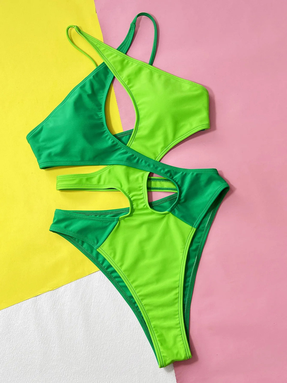 Women's solid green one-piece swimsuit with hollow contrast detail.