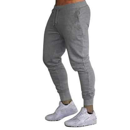 Men's cotton skinny sports trousers with drawstring and belt, available in five solid colours