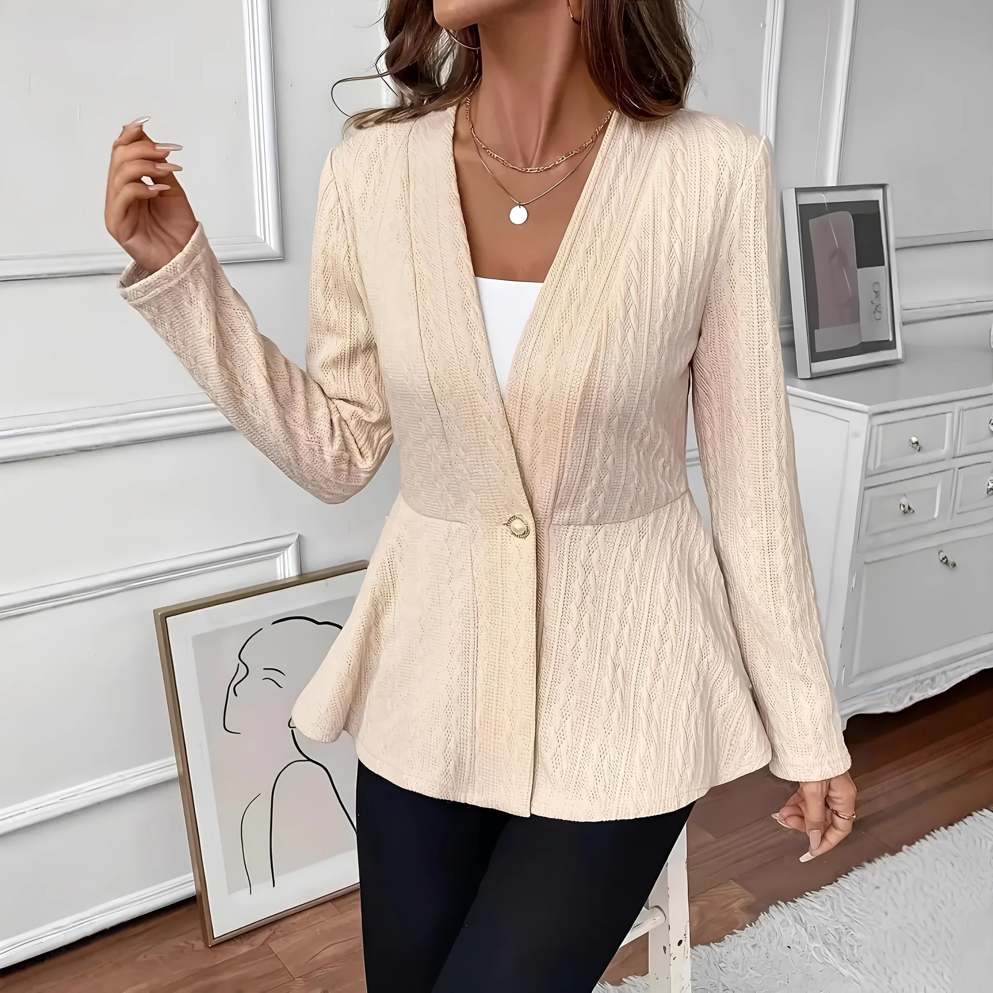 Women's apricot coloured knitted cardigan with jacquard pattern and one button front closure.