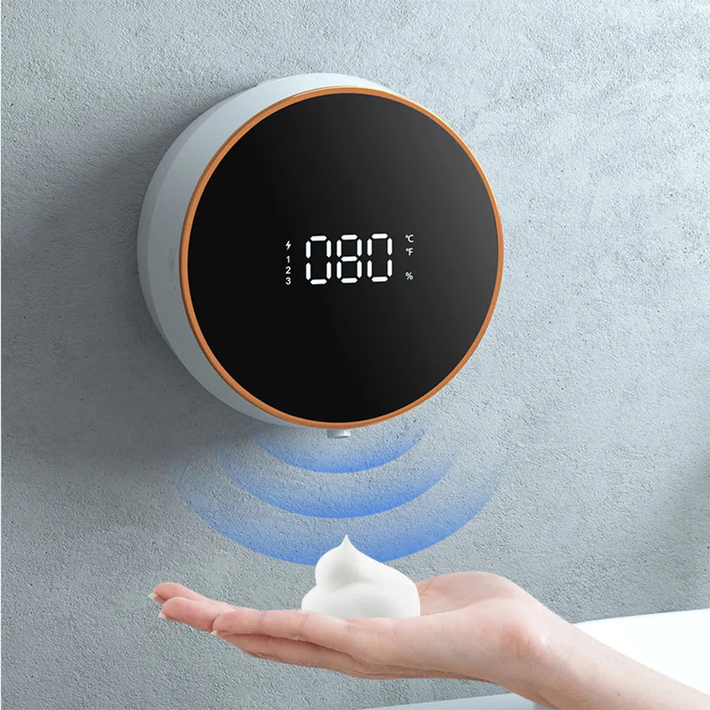 Black smart auto sensing foam dispenser mounted on a wall with USB charging cable, showing infrared sensor and foam output