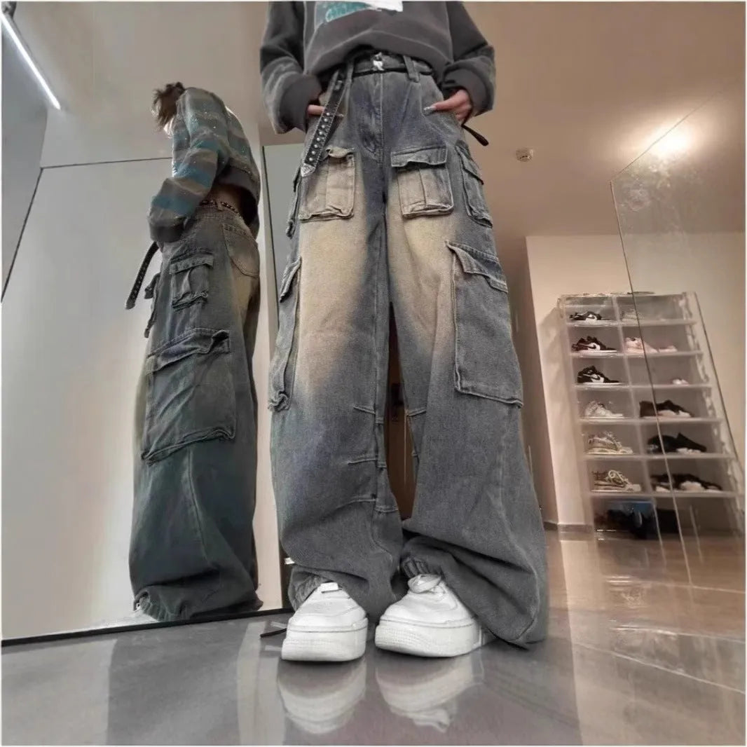Loose multi-pocket distressed denim pants in light blue and black on a size chart.