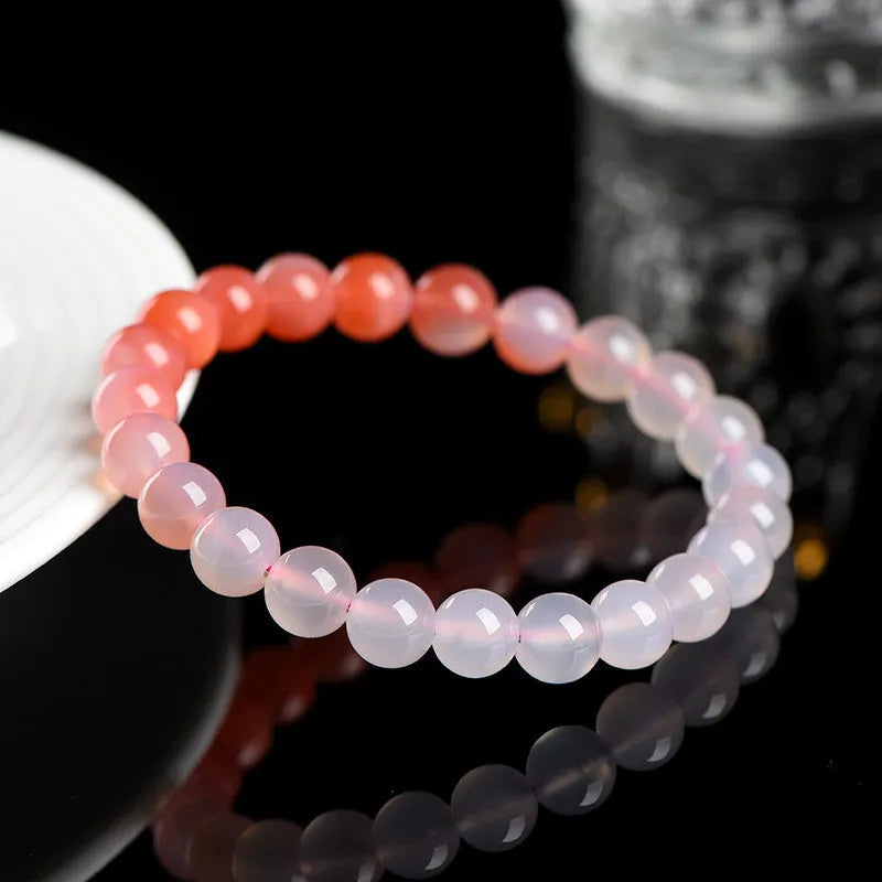 Natural gradient Yanyuan agate bracelet with geometric beads on a white background.