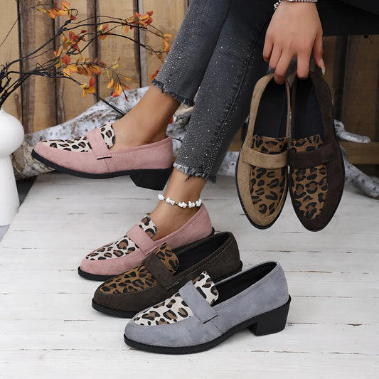 Leopard print slip-on suede pump shoe with chunky mid heel and pointed toe on a rubber sole.