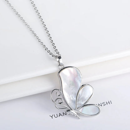 Abalone shell pendant necklace with copper electroplated animal zodiac design and butterfly or dragonfly detail