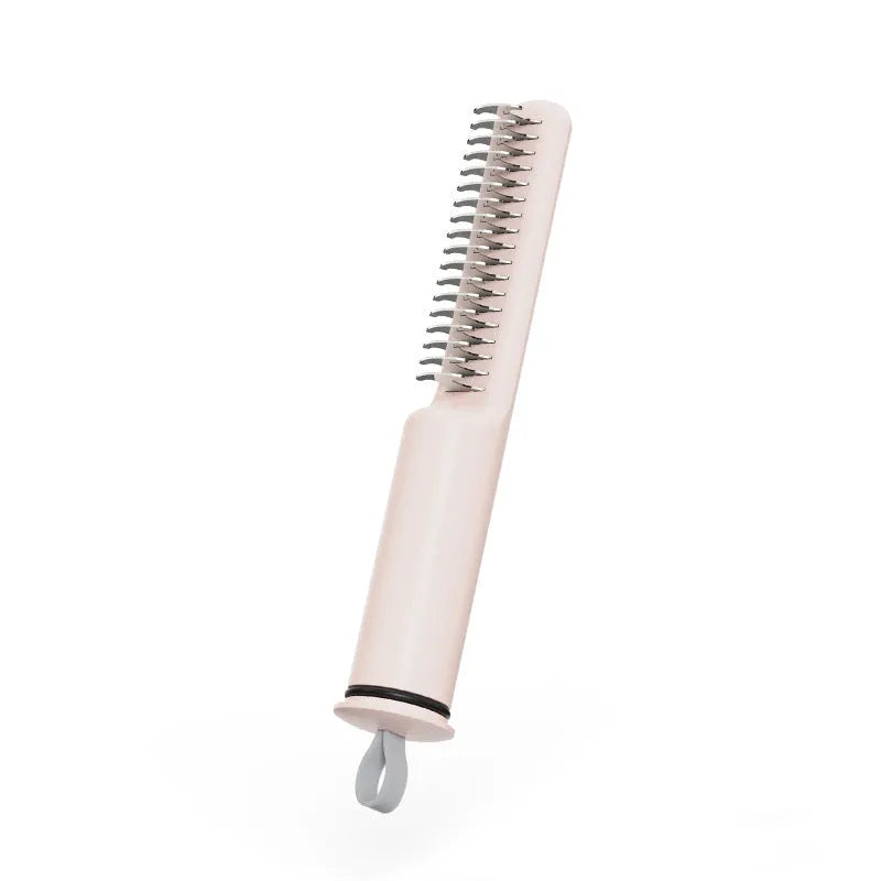 Stainless steel dog dematting comb with ergonomic handle, shown in pink colour on a white background.