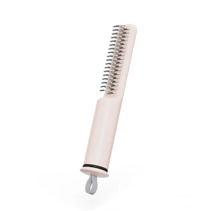 Stainless steel dog dematting comb with ergonomic handle, shown in pink colour on a white background.