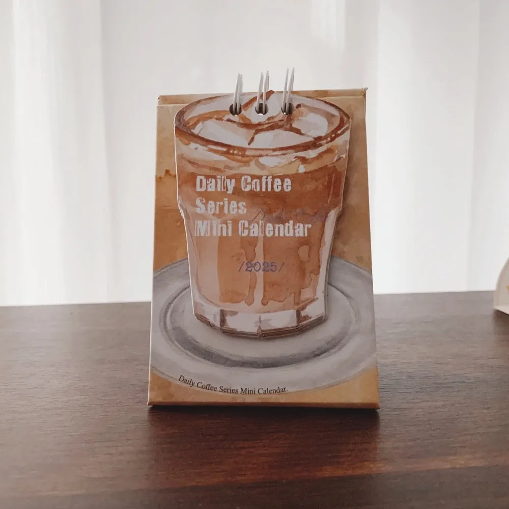 2025 mini desk calendar showing one of four designs: Coffee Time, Awake Time, Corner Perching, or Afternoon Lazy.