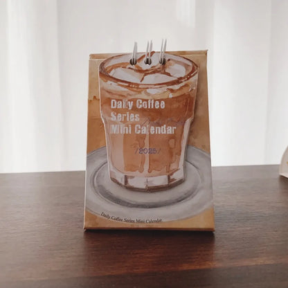 2025 mini desk calendar showing one of four designs: Coffee Time, Awake Time, Corner Perching, or Afternoon Lazy.