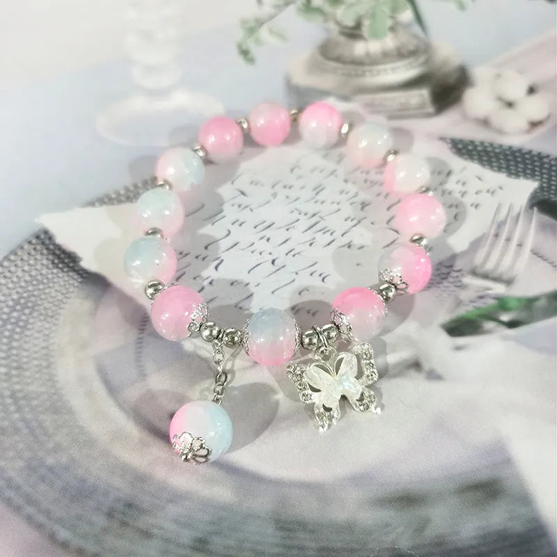 Chinese style glass bead bracelet with bamboo joint design on wrist.