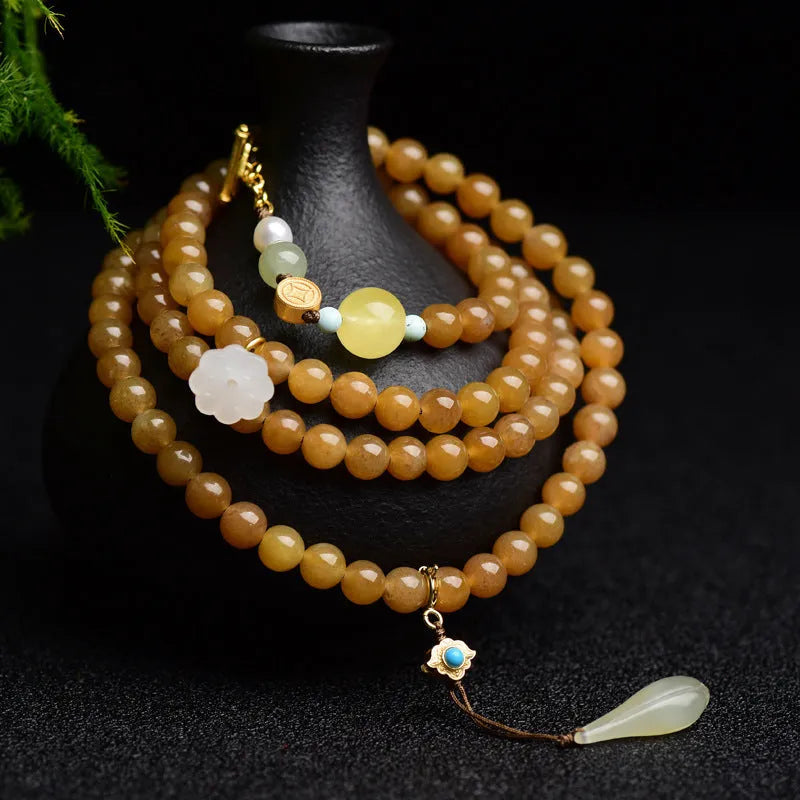 Women's bracelet with green pine beads, beeswax elements, leaf shapes, and sequin accents