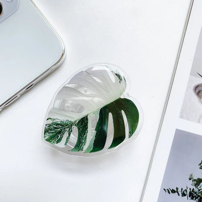 Stylish leaf-inspired smartphone stand with secure grip and adjustable viewing angle for hands-free use