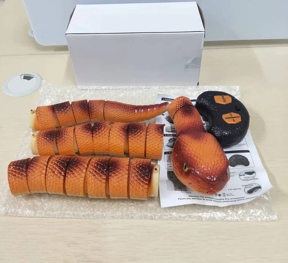 Smart sensing electronic snake cat toy with segmented body for realistic slithering motion on floor.