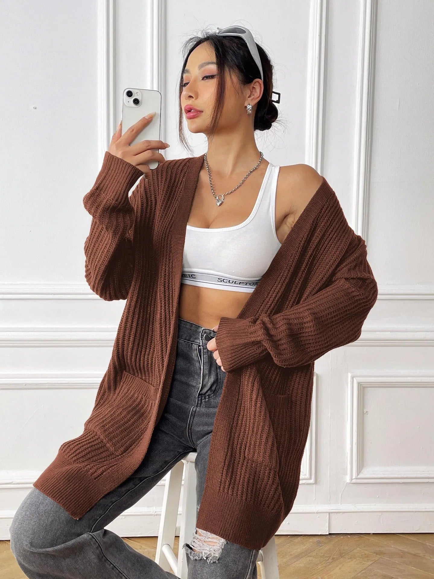 Women's dark green cardigan with two front pockets, 65cm length, loose fit design with long sleeves