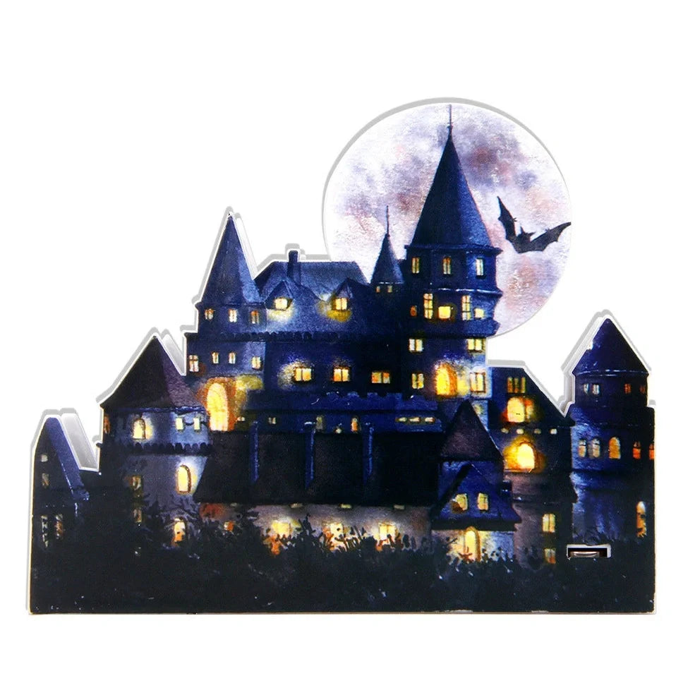 LED illuminated castle ornament with turrets and textured surfaces on desktop