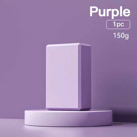 Blue EVA foam yoga block on a yoga mat, showing 23x15x7.6cm dimensions and textured surface for grip