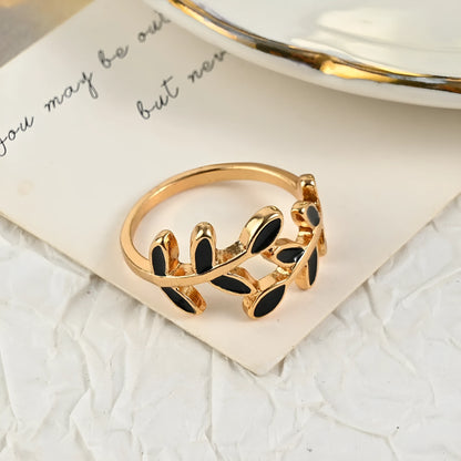 Gold electroplated geometric ring with leaf motif and acrylic accents for women's index finger