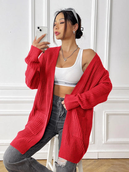Women's dark green cardigan with two front pockets, 65cm length, loose fit design with long sleeves
