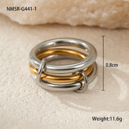 Stacked stainless steel rings with 18K gold plating in three colour variations, exaggerated hand jewellery designs