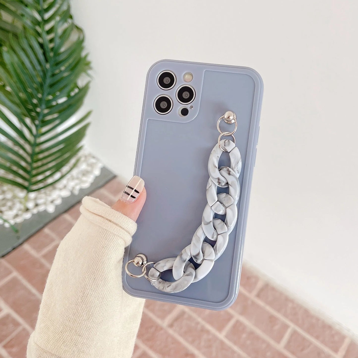 Silicone iPhone case with marble bracelet pattern and side lanyard hole in grey blue colour.